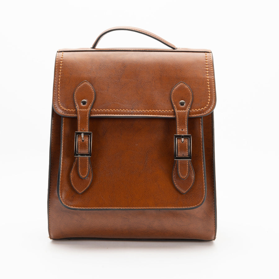 A brown leather backpack with a structured silhouette, featuring a front flap with two buckles, a top handle and shoulder straps.
