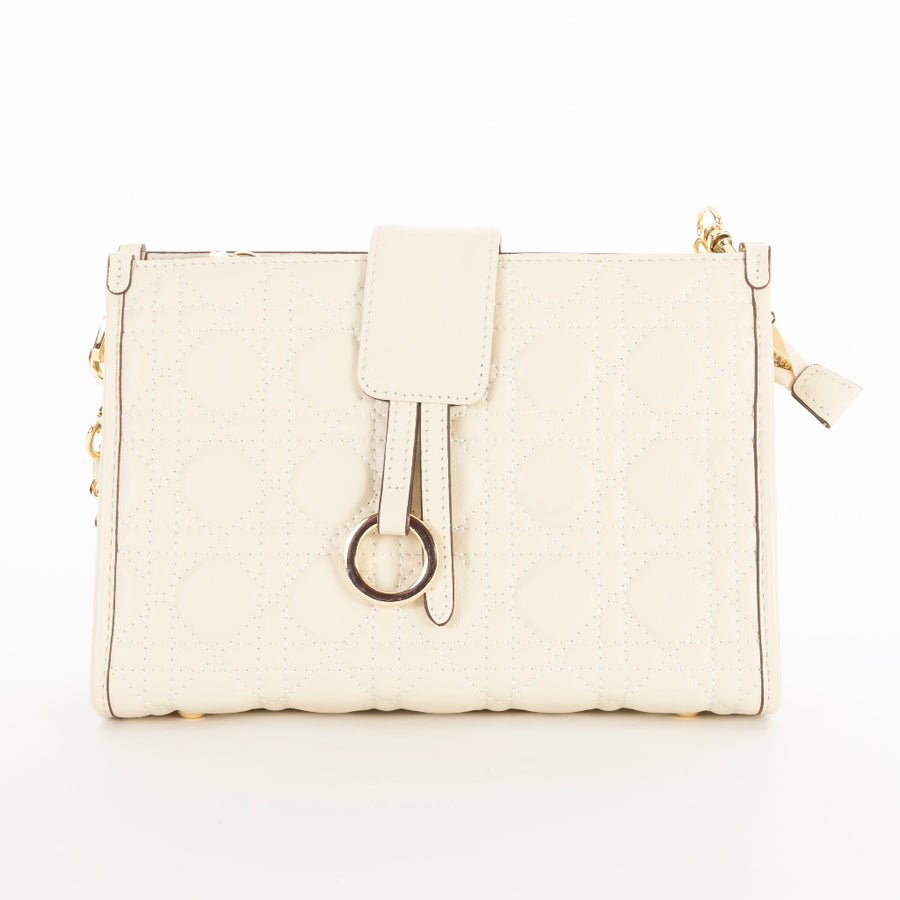 A white quilted pattern handbag with geometric accents and a chain shoulder strap.