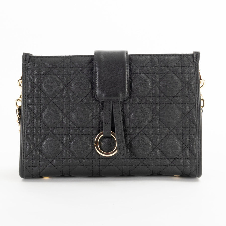 A black quilted pattern handbag with geometric accents and a chain shoulder strap.