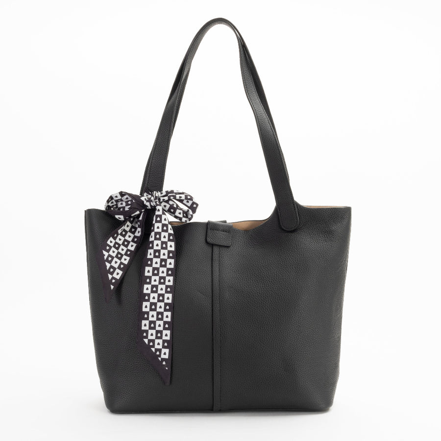 A black leather tote bag with a detachable scarf in a zippered compartment, displayed against a plain background.