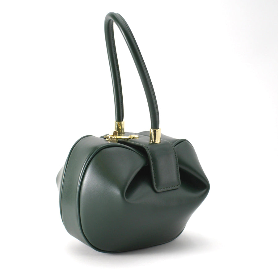 A green, handcrafted leather handbag with a top handle.